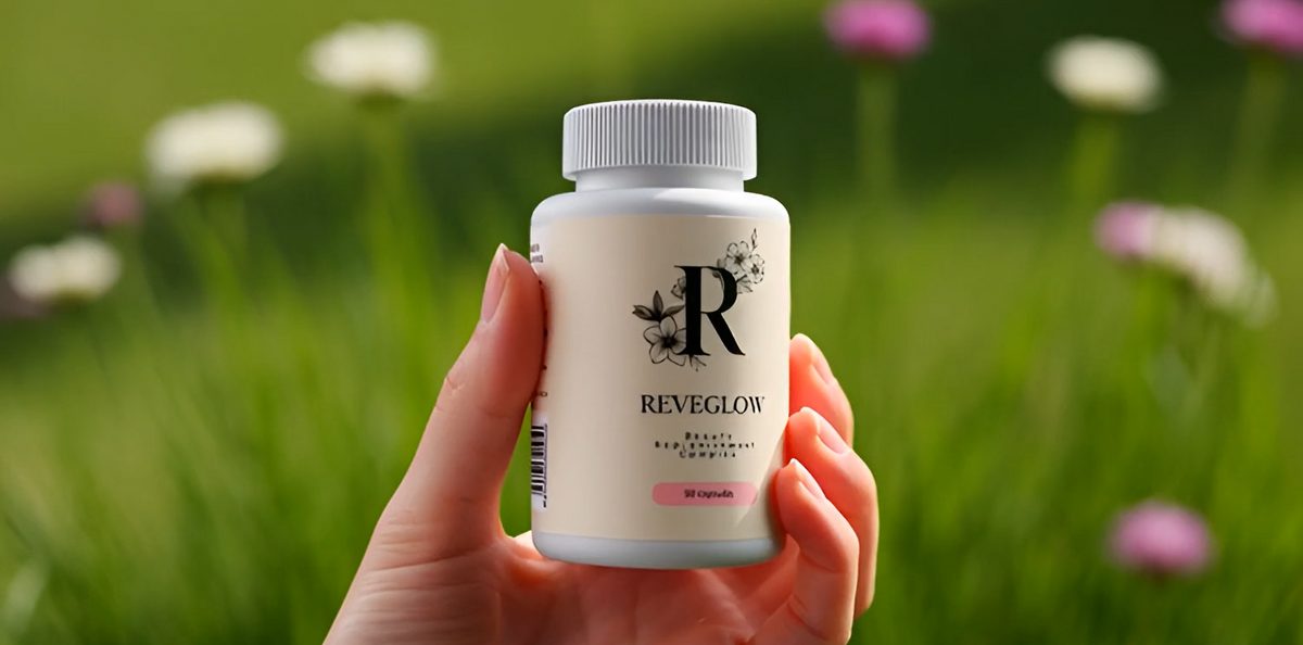 Hand holding a Reveglow bottle in a field of flowers