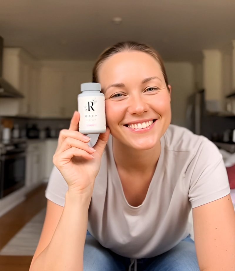 Smiling woman holding a bottle of Reveglow